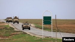 FILE - U.S. military vehicles are seen near Hasakah, Syria, Nov. 4, 2018.