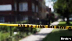 FILE - Police crime scene tape is posted at the scene of a shooting on the South Side of Chicago, July 26, 2020. 