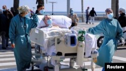 Un paciente recibe una "terapia de mar" después de pasar 114 días enfermo de COVID-19 en un hospital de Barcelona, España, el 25 de marzo de 2021.