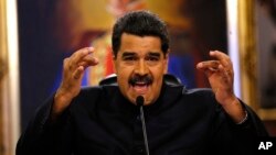 FILE - Venezuela's President Nicolas Maduro gives a news conference in Caracas, Venezuela, June 22, 2017. Maduro said a helicopter fired on Venezuela's Supreme Court June 27 in a confusing incident that he claimed was part of a conspiracy to destabilize his socialist government.