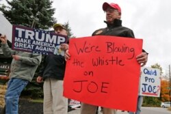 FILE - Supporters of President Donald Trump picket outside an event for Democratic presidential candidate Joe Biden at a campaign stop in Manchester, N.H., Oct. 9, 2019.