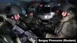 Russian service members sit inside a military vehicle as they take part in tactical exercises of an assault engineering unit at a training ground in Kamensk-Shakhtinsky in the Rostov region, Russia January 17, 2022. (Sergey Pivovarov/Reuters)