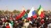 Demonstrators gather in Ouagadougou to show support to the military while holding and waiving a Russian flag in the aftermath of the coup d'etat in Burkina Faso which overthrew President Roch Marc Christian Kabore, January 25, 2022. (AFP)