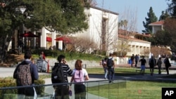 FILE - In this Feb. 2, 2012, photo, students walk through the campus of Claremont McKenna College in Claremont, Calif.