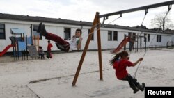 FILE - Children play in a playground at the camp for migrants and refugees in Friedland, Germany, April 4, 2016. (REUTERS/Kai Pfaffenbach)