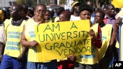 FILE: Zimbabwean vendors hold banners urging the government to stop their forced removals from the street during a demonstration in Harare, Wednesday, June, 24, 2015. Hundreds of vendors took to the streets of Harare demonstrating against an impending eviction from the streets, saying they will not move despite a Friday deadline to do so. (AP Photo/Tsvangirayi Mukwazhi)