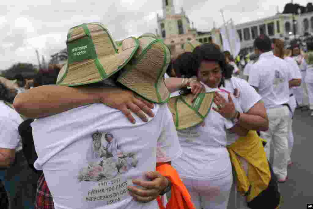 A group of pilgrims from Lisbon embrace after their arrival at the Sanctuary of Our Lady of Fatima, in Fatima, Portugal. On Saturday Pope Francis will canonize two poor, illiterate shepherd children whose visions of the Virgin Mary 100 years ago marked one of the most important events of the 20th-century Catholic Church.&nbsp;