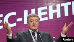 FILE - Ukraine's president and presidential candidate Petro Poroshenko delivers a speech following the announcement of the first exit poll in a presidential election at his campaign headquarters in Kyiv, Ukraine, March 31, 2019.