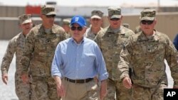 US Secretary of Defense Robert M. Gates walks with a group of service members at Forward Operating Base Waltman, Kandahar, Afghanistan, June 5, 2011