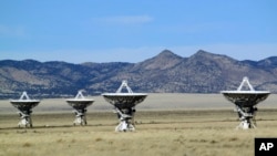 FILE - This Feb. 10, 2017, photo shows a few of the radio antennas that make up the Very Large Array astronomical observatory, which are positioned on tracks on the Plains of San Augustin west of Socorro, N.M. 