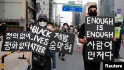 FILE - People march on the street in solidarity with protests against the death in Minneapolis police custody of George Floyd, in Seoul, South Korea, June 6, 2020. 