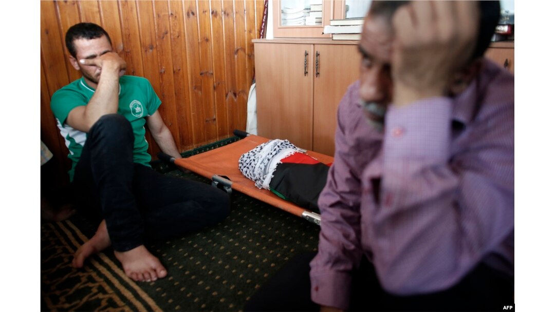 Relatives of 18-month-old Palestinian toddler Ali Saad Dawabsha, who died after his house was set on fire by Jewish settlers, mourn next to his body lying at a mosque during his funeral in the West Bank village of Duma, July 31, 2015.
