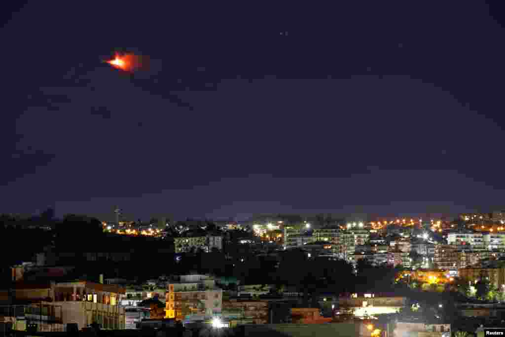 An eruption from Mount Etna lights up the sky during the night, seen from Catania, Italy, Jan. 4, 2021.