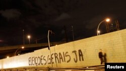 A man walks past a grafitti on a wall reading "General Elections, Now" in Sao Paulo, Brazil, April 12, 2017. 