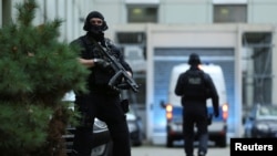 FILE - German police arrive with a suspect (not pictured) in a planned Islamic State bomb attack, at a courthouse in Frankfurt, Germany, Nov. 13, 2019. Separately, a returning national was arrested Nov. 15 in Frankfurt on suspicion of being an IS member.