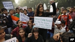 Indian students carrying placards shout slogans against last week's gang-rape as they protest in central New Delhi, India, Dec. 24, 2012.