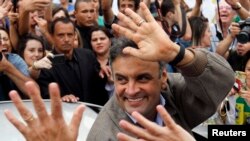 FILE - Brazil's presidential candidate Aecio Neves of Brazilian Social Democratic Party (PSDB) greets supporters in Sao Joao del Rei, Oct. 25, 2014. 