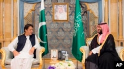 In this photo released by the state-run Saudi Press Agency, Pakistani Prime Minister Imran Khan, left, meets Saudi Crown Prince Mohammed bin Salman, Sept. 19, 2018, in Jiddah, Saudi Arabia.