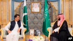 In this photo released by the state-run Saudi Press Agency, Pakistani Prime Minister Imran Khan, left, meets Saudi Crown Prince Mohammed bin Salman, Sept. 19, 2018, in Jiddah, Saudi Arabia.