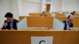 FILE Bordeaux Mayor Pierre Hurmic, background center, Chief Operating Officer of French National Centre for Space Studies (CNES) Lionel Suchet , right, attend a tasting of normal bottles of red wine and others that spent a year orbiting the world in the International Space Station, in Villenave-d'Ornon, southwestern France, Monday, March 1, 2021. Researchers in Bordeaux are carefully studying a dozen bottles of French wine that returned to Earth after a stay aboard the International Space Station. (AP Photo/Christophe Ena)