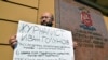 FILE - Russian journalist Ilya Azar protests in support of detained journalist Ivan Golunov outside the headquarters of the Moscow branch of the Russian Interior Ministry in Moscow, June 7, 2019.