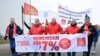 FILE - Employees of Volkswagen AG march for higher wages in front of the Osnabrueck Volkswagen plant during a 'warning strike' of Germany's IG Metall metalworkers' union, in Osnabrueck, Germany, November 6, 2024.