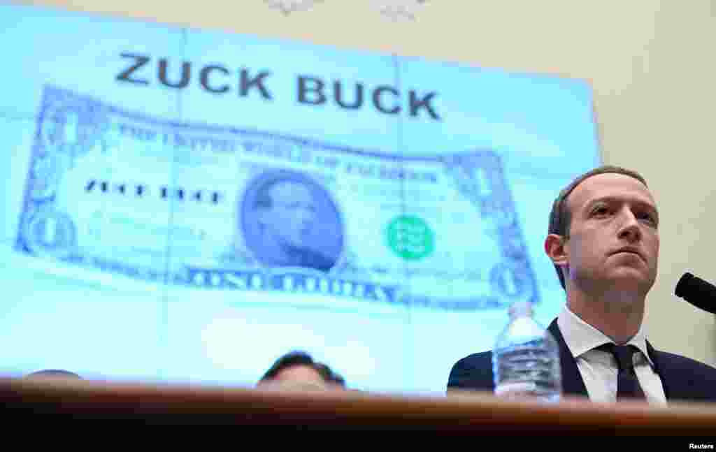 Facebook Chairman and CEO Mark Zuckerberg testifies in front of a projection of a &quot;Zuck Buck&quot; at a House Financial Services Committee hearing examining the company&#39;s plan to launch a digital currency, on Capitol Hill in Washington.