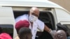 FILE - Sudan's ousted President Omar al-Bashir disembarks from a vehicle upon arriving at a courthouse to attend his trial, in Khartoum, in this AFPTV screen grab from footage aired July 21, 2020.