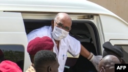 FILE - Sudan's ousted President Omar al-Bashir disembarks from a vehicle upon arriving at a courthouse to attend his trial, in Khartoum, in this AFPTV screen grab from footage aired July 21, 2020.