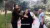 Screen grab from a phone video sent to VOA Persian by a dog walker who said the man on the left punched him for walking a dog in Tehran’s Ab-o-Atash park Thursday. The woman in the black chador is the wife of the alleged assailant.