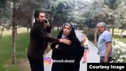 Screen grab from a phone video sent to VOA Persian by a dog walker who said the man on the left punched him for walking a dog in Tehran’s Ab-o-Atash park Thursday. The woman in the black chador is the wife of the alleged assailant.