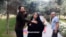 Screen grab from a phone video sent to VOA Persian by a dog walker who said the man on the left punched him for walking a dog in Tehran’s Ab-o-Atash park Thursday. The woman in the black chador is the wife of the alleged assailant.