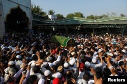 FILE - Supporters carry the coffin of Ko Ni, a prominent member of Myanmar's Muslim minority and legal adviser for Myanmar's ruling National League for Democracy, after he was shot dead, in Yangon, Myanmar, Jan. 30, 2017.