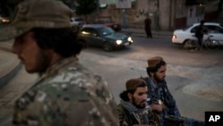 Taliban fighters ride in the back of a pickup truck as they patrol the streets of Kabul, Afghanistan, Sept. 18, 2021.