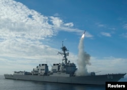 FILE - Sailors aboard the guided-missile destroyer USS Preble work off the coast of California, Sept. 29, 2010. On Wednesday, the ship passed through the strait separating Taiwan from China.