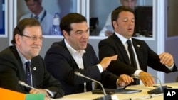 Greek Prime Minister Alexis Tsipras, center, speaks during a round table meeting at an emergency summit of eurozone heads of state and government at the EU Council building in Brussels, Belgium, July 7, 2015. 