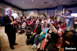 Matthew Schoenberger, of New Orleans, shouts a question at Republican U.S. Senator Bill Cassidy during a town hall meeting in Metairie, Louisiana, Feb. 22, 2017.