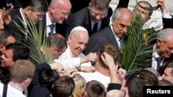 Pope Francis greets young people after leading Palm Sunday mass, April 13, 2014.