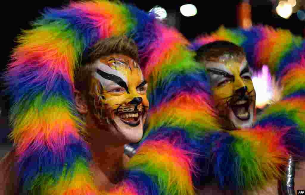 Participants march during Sydney&#39;s annual gay and lesbian Mardi Gras night parade in Australia. Some 10,000 revelers on 144 individual floats marked the journey down Oxford Street, hub of the city&#39;s gay and lesbian nightlife, in a vibrant show featuring drag queens, political parodies and plenty of glitter.