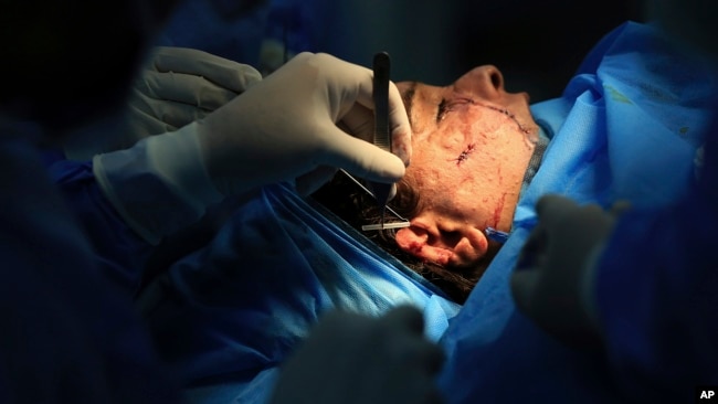 Plastic surgeon Dr. Abbas al-Sahan performs reconstructive surgery on Saja Ahmed Saleem, in Baghdad, Iraq, Nov. 6, 2018. Those whom treatment not available at state-run hospitals and can’t afford treatment at private clinics rely on social media to make an appeal.