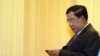 FILE - Cambodian Prime Minister Hun Sen looks at his smartphone in Phnom Penh, Feb. 25, 2016. The Cambodian government has condemned Facebook “attacks” on Hun Sen as “highly offensive.”
