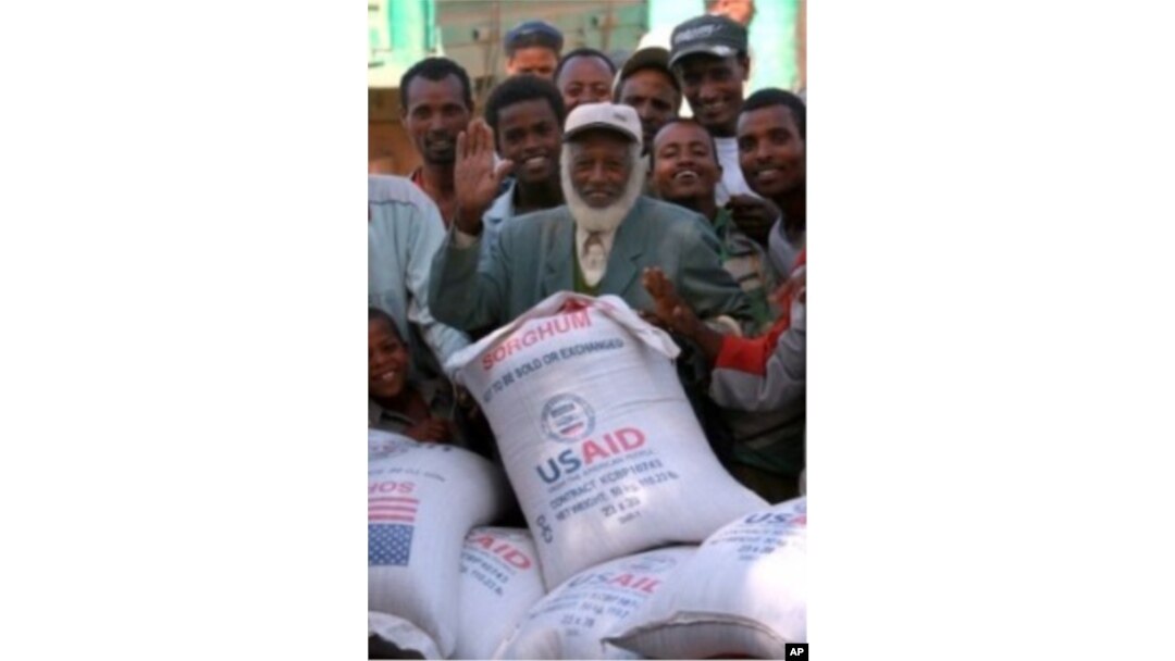 A man receives 50 kilograms of US sorghum in southern Ethiopia during 2010.