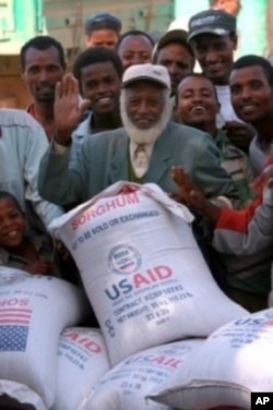 A man receives 50 kilograms of US sorghum in southern Ethiopia during 2010.
