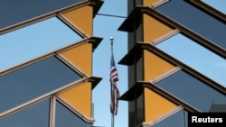 The U.S. flag is reflected on the windows of the U.S. Embassy in Kabul, Afghanistan, July 30, 2021. 