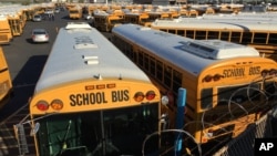 FILE - Los Angeles School District buses are parked at their bus garage in Gardena, California, Dec. 15, 2015. 