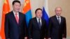 From right: Russian President Vladimir Putin, Mongolian President Tsakhiagiin Elbegdorj and Chinese President Xi Jinping pose during their meeting at the sidelines of the Shanghai Cooperation Organization summit in Dushanbe, Tajikistan, Sept. 11, 2014. 