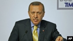 Turkey's Prime Minister Recep Tayyip Erdogan presses for NATO to have sole control over all military operations in Libya during a conference at his office in Istanbul, March 24, 2011