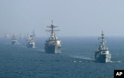 Warships from various countries take part in multinational military exercise, “Aman” or peace exercise in the Arabian Sea near Karachi, Pakistan, Monday, Feb. 15, 2021.