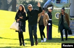 FILE - President Barack Obama waves as he walks with first lady Michelle Obama (R) and their daughters Malia (L) and Sasha on the South Lawn of the White House, Jan. 3, 2016. The Obama family returned from Hawaii, the president's home state,