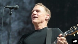 FILE - Singer-songwriter Bryan Adams performs in concert during his “Reckless - 30th Anniversary Tour 2015” at the Delaware State Fair, July 28, 2015.